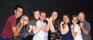 The cast of Rosies line up to flex their workshop muscles reminiscent of Rosie the Riveter.