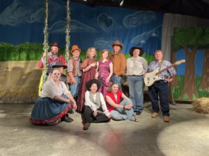 The cast of As You Like It, FbTC 2023. The characters are dressed in cowboy attire.